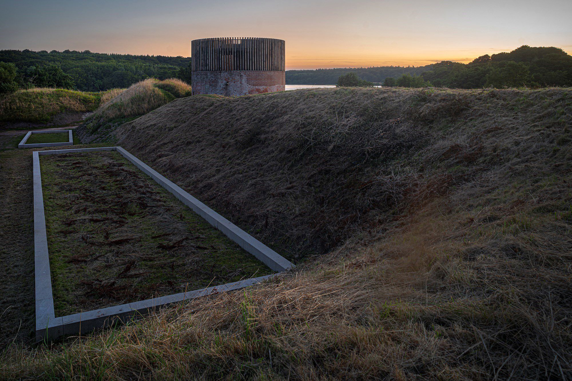 Solnedgangsbillede af Hald Slot og voldene og kig til Hald Sø